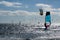 Windsurfers and kitesurfers at the ocean glistening in the sun in backlight