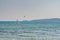 Windsurfers and kitesurfers ride on Navarino bay near Pylos city, Greece