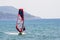 Windsurfers and kitesurfers ride on Navarino bay near Pylos city, Greece