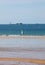 Windsurfers surfing along the beach in Saint Malo. Brittany, France