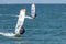 Windsurfers on the waves of the Amur Bay on a cold windy autumn day