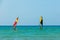 Windsurfing on the background of the sea landscape and clear sky.Two windsurfers men go in for sports, copy space