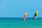 Windsurfing on the background of the sea landscape and clear sky.Two windsurfers men go in for sports, copy space