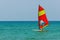 Windsurfing on the background of the sea landscape and clear sky. Windsurfer male go in for sports, copy space