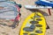 Windsurfing board with sail lying on the sand