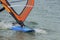 Windsurfing details. A windsurfer rides on the sea