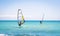 Windsurfing sails on the blue sea