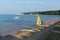 Windsurfing at Studland beach Dorset UK in the summer with the chalk cliffs