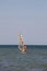 Windsurfing. Surfer exercising in calm sea or ocean.