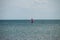 Windsurfing. Surfer exercising in calm sea or ocean