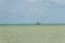 Windsurfing. Surfer exercising in calm sea or ocean