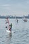 Windsurfing training. Several children floating on boards with sail on lake