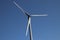 Windturbine in close-up with blue sky as background in the Netherlands