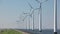 Windturbines in the water with a clear blue sky