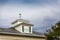 Windvane on Cupola on Cloudy Day