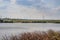 Windwheels ,lake and a field in rural Ukraine. Wind farm near the village