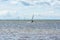 On a windy day many people take the opportunity to do watersports. Windsurfers gather near Lomma beach to practice their