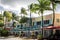 Windy palm trees in fron of colorful house on ocean drive