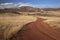 Windy ranch road in mountain valley