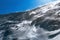 Windy snow blow on ice slope alpine hiking path, Italy