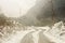 Windy snowy foggy slippery muddy flat step himalayan mountain road in winter. Leh Manali Highway, Jammu and Kashmir, India, Asia