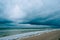 Windy storm beach sea waves with dark clouds