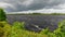 Windy summer landscape from swamp lake, wind and turbulence of lake water, lake shore, trees in wind, swamp lake