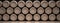 Wine barrels stack on wooden floor, black background. 3d illustration