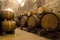 Wine barrels stacked in the old cellar of the winery.