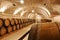 Wine barrels in winery basement.