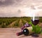 Wine bottle, glass and red grape on wineyard background