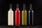 Wine bottles collection different colors, mock up on elegant dark black wooden background.