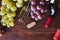 Wine bottles, grape and corkscrew top view on wood backdrop