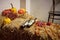 Wine bottles, pumpkins and peppers on haystack