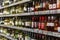 Wine bottles on shelves in a store. Large assortment of alcohol. Blurred