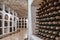 Wine bottles stacked up in old wine cellar close-up