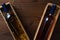 Wine bottles in wood boxes on a rustic wooden table. The individual boxes are at an angle with copy space