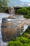 Wine casks at the winery. Wine barrels outside of wine cellar in the garden of a picturesque vineyard. Winery garden