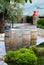 Wine casks at the winery. Wine barrels outside of wine cellar in the garden of a picturesque vineyard. Winery garden in details