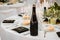 Wine champagne cider dark glass bottle blanck space in fancy table set in restaurant event celebration