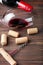 Wine corks, corkscrew and glass with a red wine