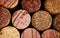 Wine corks side by side in a pile macro close-up background. The used corks display different hues, colours and textures