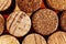 Wine corks side by side in a pile macro close-up background. The used red wine corks display different hues, colours and textures