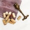 Wine corks with vintage corkscrew on white wooden surface