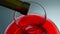 Wine drops falling glass decanter closeup. Blob splashing from bottle neck