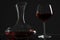 Wine glass and carafe with red wine