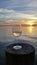 Wine glass on dock post at sunset in Islamorada, Florida.
