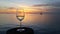 Wine glass on dock post at sunset in Islamorada, Florida.