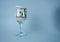 Wine glass with money highlighted on a blue background