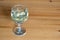 Wine glass on table coins  money spent on alcohol closeup